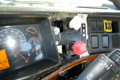 Volvo VNM42T dashboard view showing gauges, red knob, and switch panel with yellow numbered label 13.