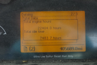 Dashboard odometer reading 405,689.1 miles and engine hours display showing total engine hours 22,404.0 and idle time 7,483.7 with orange data window, Ultra Low Sulfur Diesel label.
