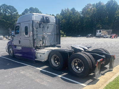 Freightliner Cascadia126 truck tractor rear view showing chassis and dual rear axle and tires.