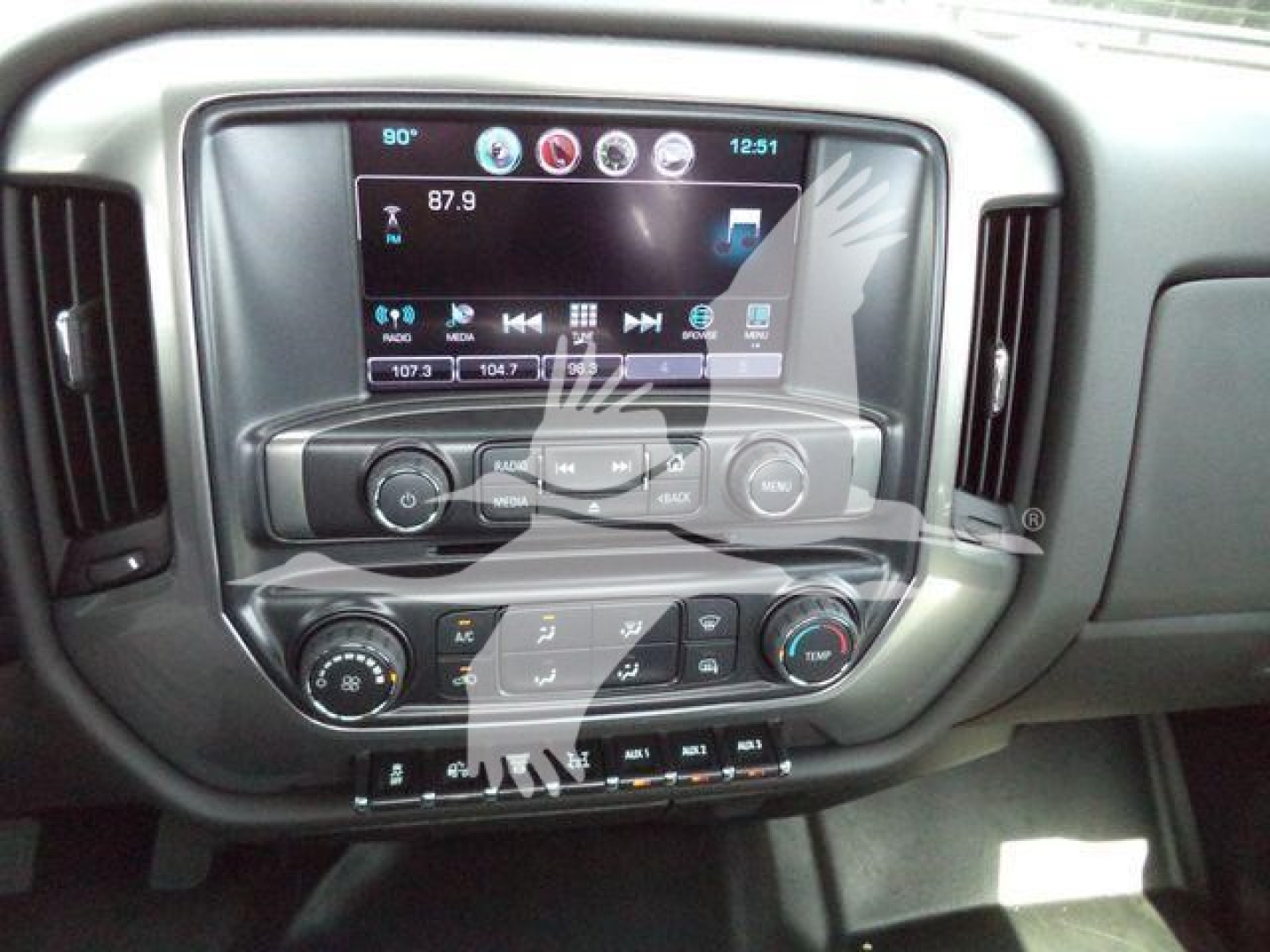 Dashboard infotainment system and climate controls of a Chevrolet Silverado 6500HD interior showing touchscreen display and control knobs.