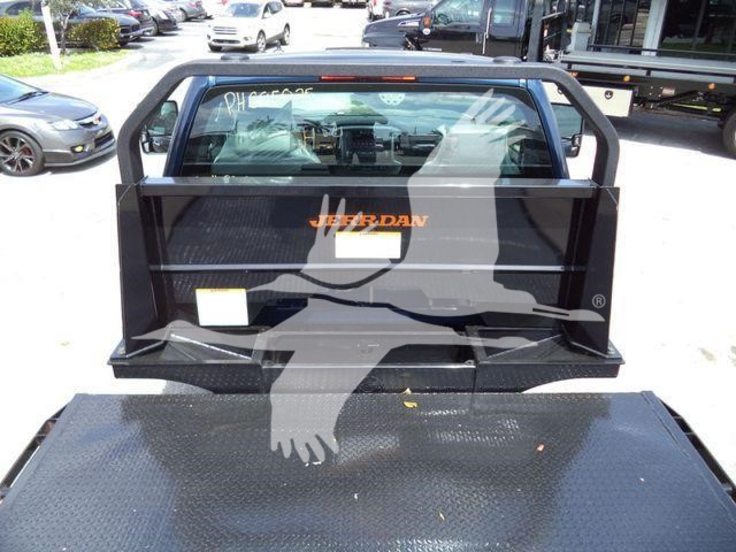 Chevrolet Silverado 6500HD truck bed with Jackson-style utility rack and flatbed surface, rear view showing tailgate area and rugged steel platform.