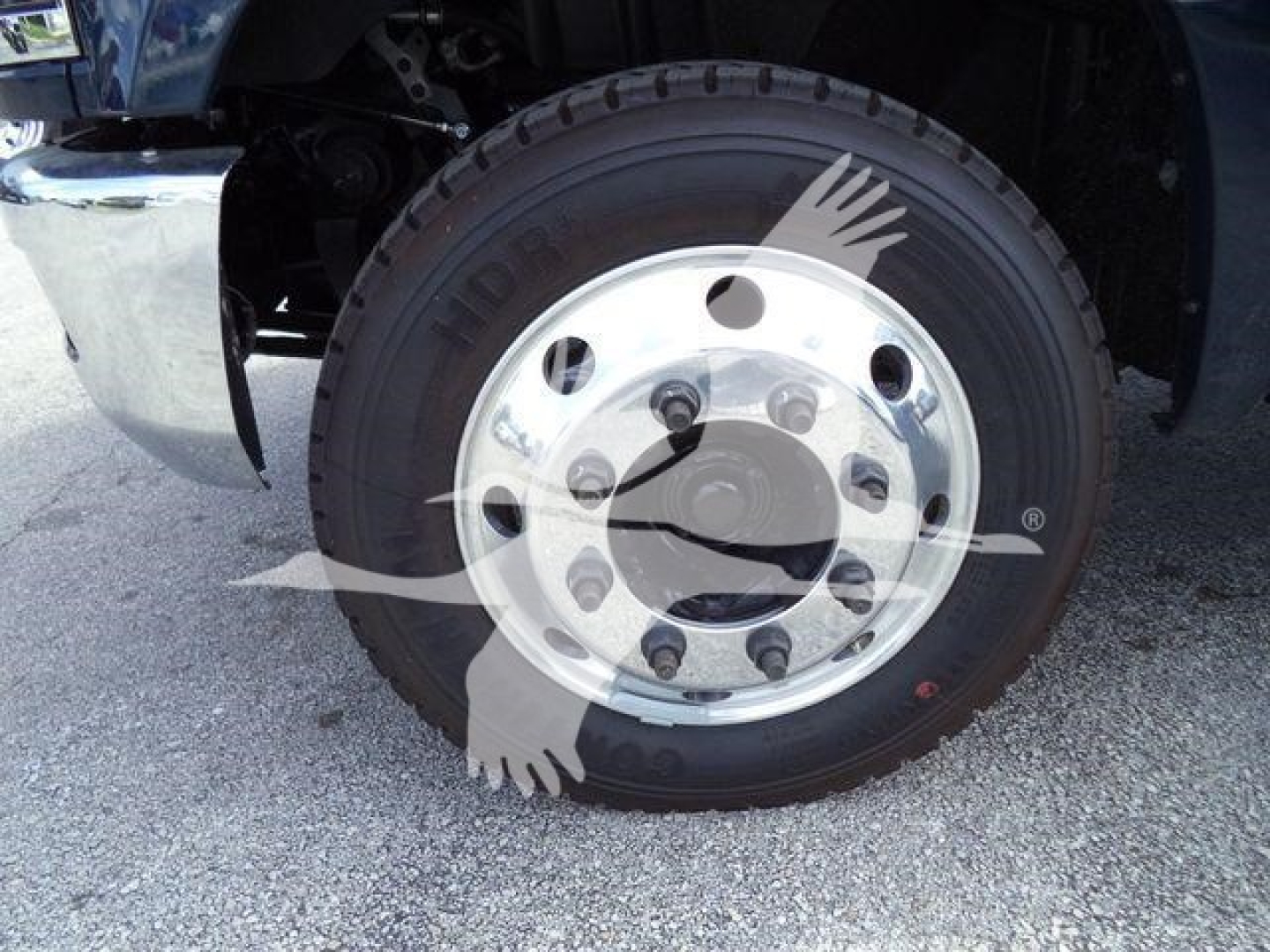 Front wheel and tire of a 2023 Chevrolet Silverado 6500HD with steel rim and tire tread visible.
