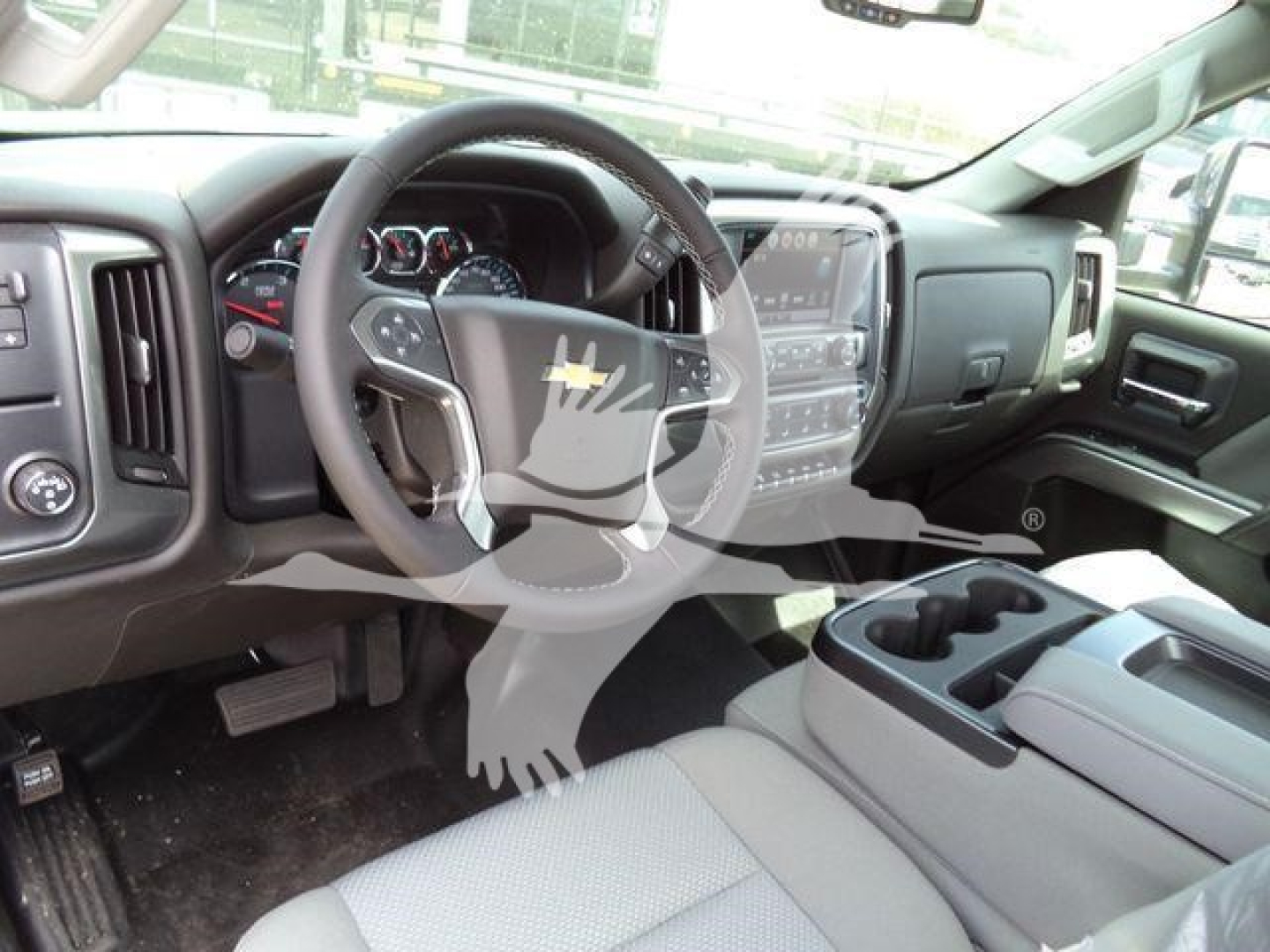 Chevrolet Silverado 6500HD interior showing steering wheel and dashboard with center touchscreen and control cluster.