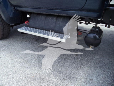 Chevrolet Silverado 6500HD truck side view showing aluminum side step with diamond tread and underbody components