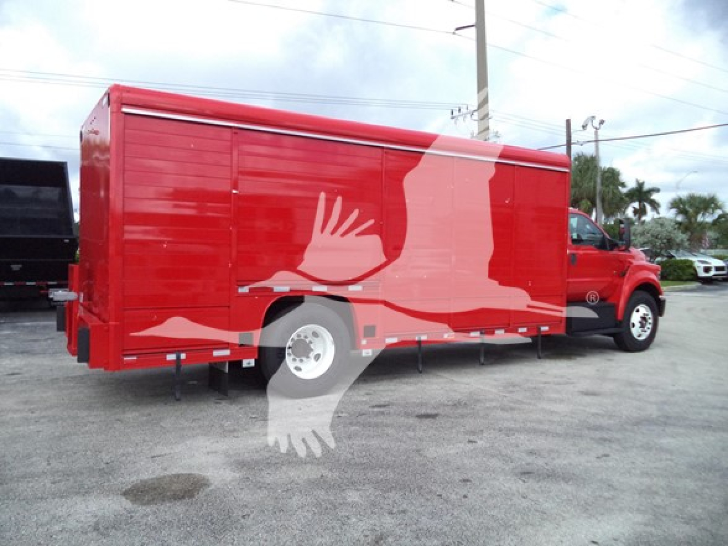 Red Ford F-Series beverage truck with cargo trailer attached, side view.