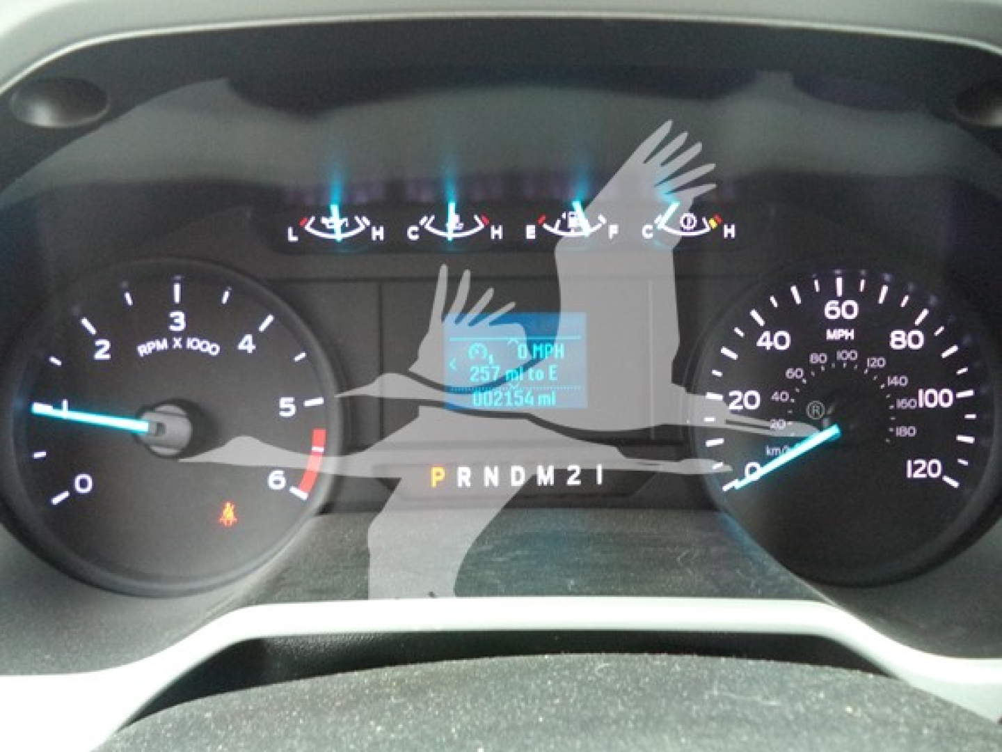 Dashboard cluster of a Ford F-650 truck showing tachometer, speedometer, and central digital display with transmission gear indicators and fuel/engine readouts.