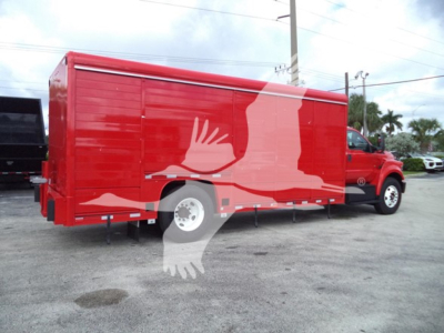 Red Ford F-Series beverage truck with cargo trailer attached, side view.