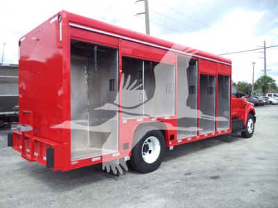 Truck body side view showing a red beverage service truck with open compartments and a white wheel, Ford F-650 style chassis.
