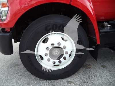 Truck front wheel area showing Goodyear tire with white steel wheel and red fender.