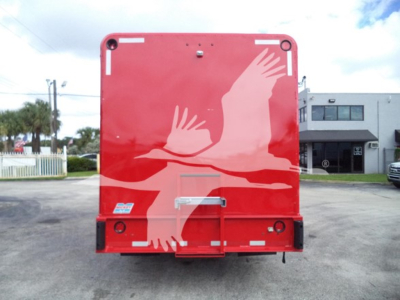 Red truck rear with a graphic of a white flying bird/wings design and a silver latch handle; no legible text.