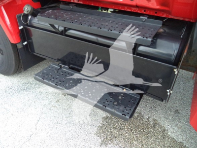 Trucks component image showing side step and storage box under cab of a Ford F650 truck with black metal boxes and perforated steps.