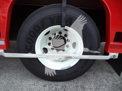 Goodyear tire with white rim on red Ford F650 truck front wheel, visible tire branding and wheel details.