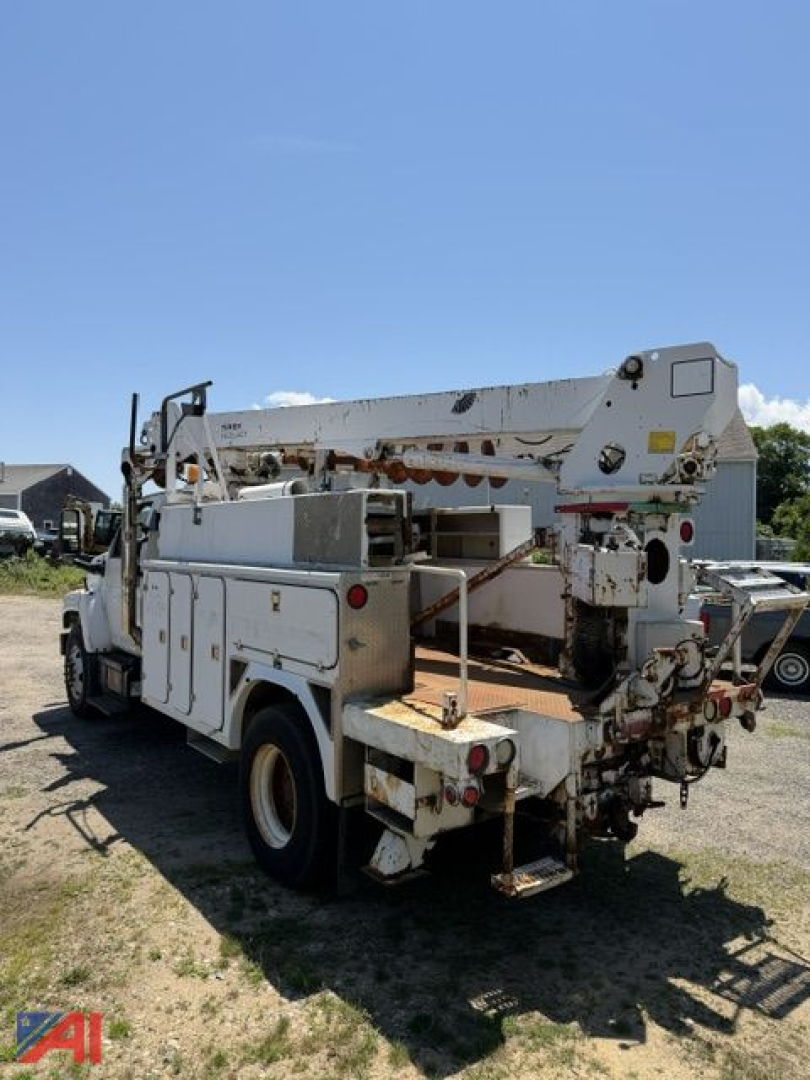 GMC C8500 digger truck rear view showing boom and utility compartments