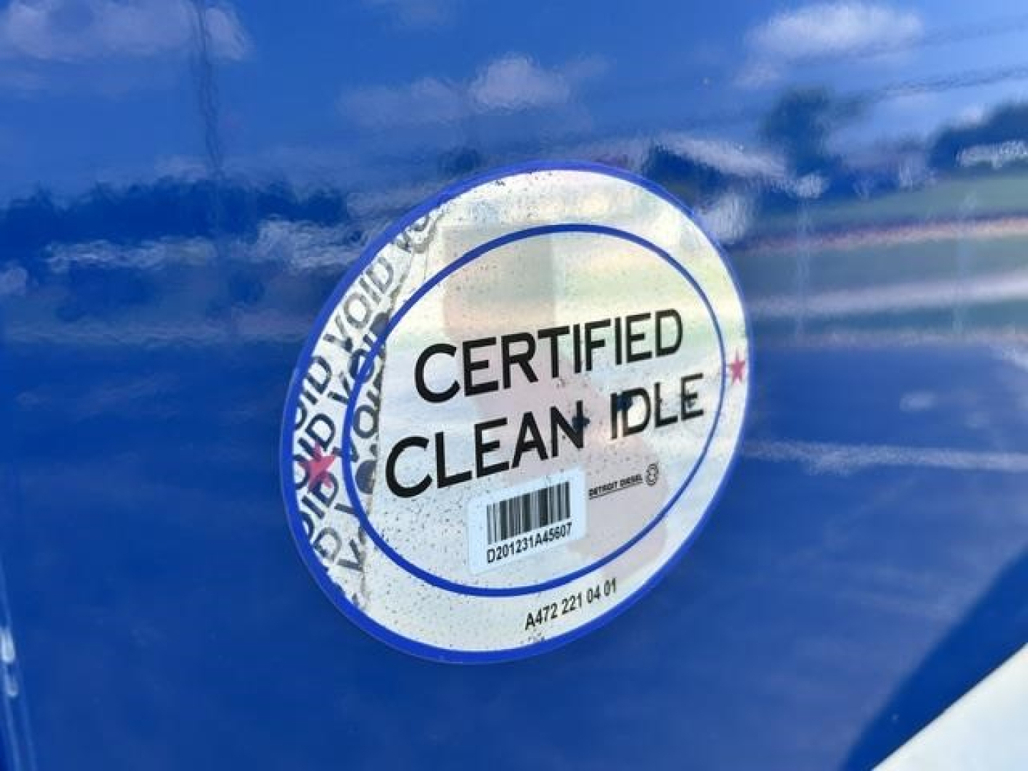 Certified Clean Idle sticker on blue Freightliner Cascadia door
