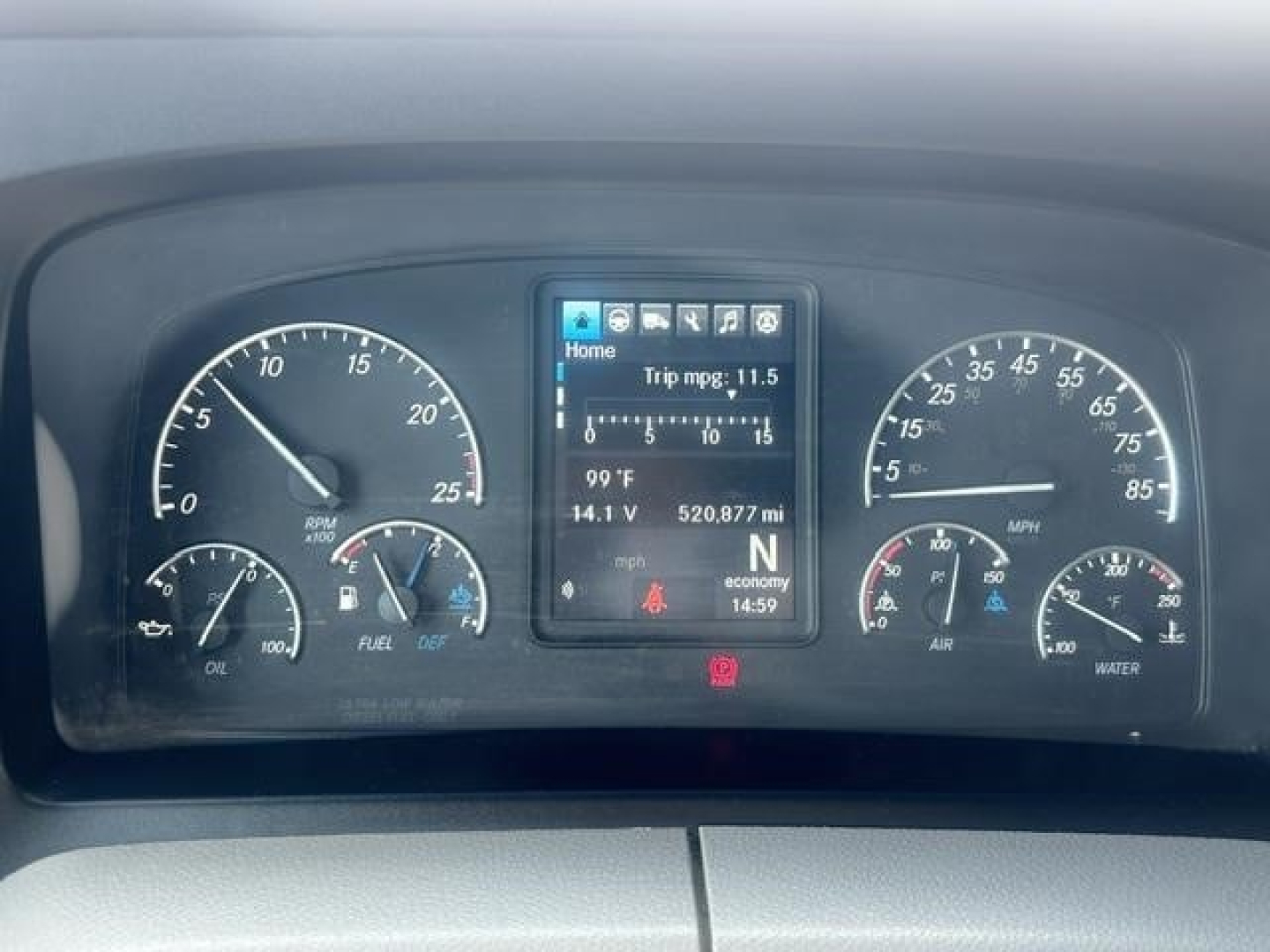 Dashboard of a Freightliner Cascadia 126 showing instrument cluster with rpm, speed, fuel, oil, and a central digital display; various readouts including coolant temp, voltage, trip mpg, and gear indicator.