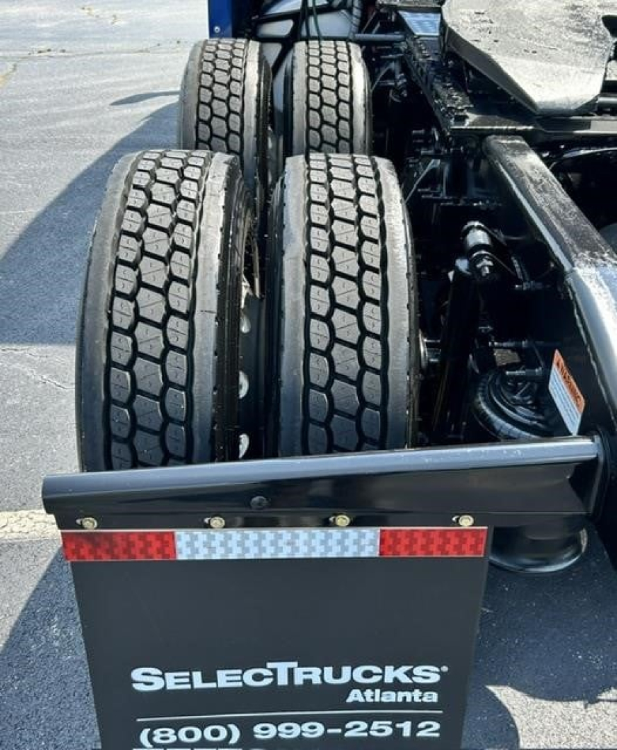 Freightliner Cascadia 126 tractor rear with dual rear axles and tire tread visible; SelectTrucks Atlanta logo plate on bumper.