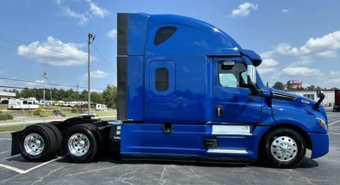 Freightliner Cascadia 126 sleeper tractor in blue, side view showing cab and wheels, no visible text on motors or decals.