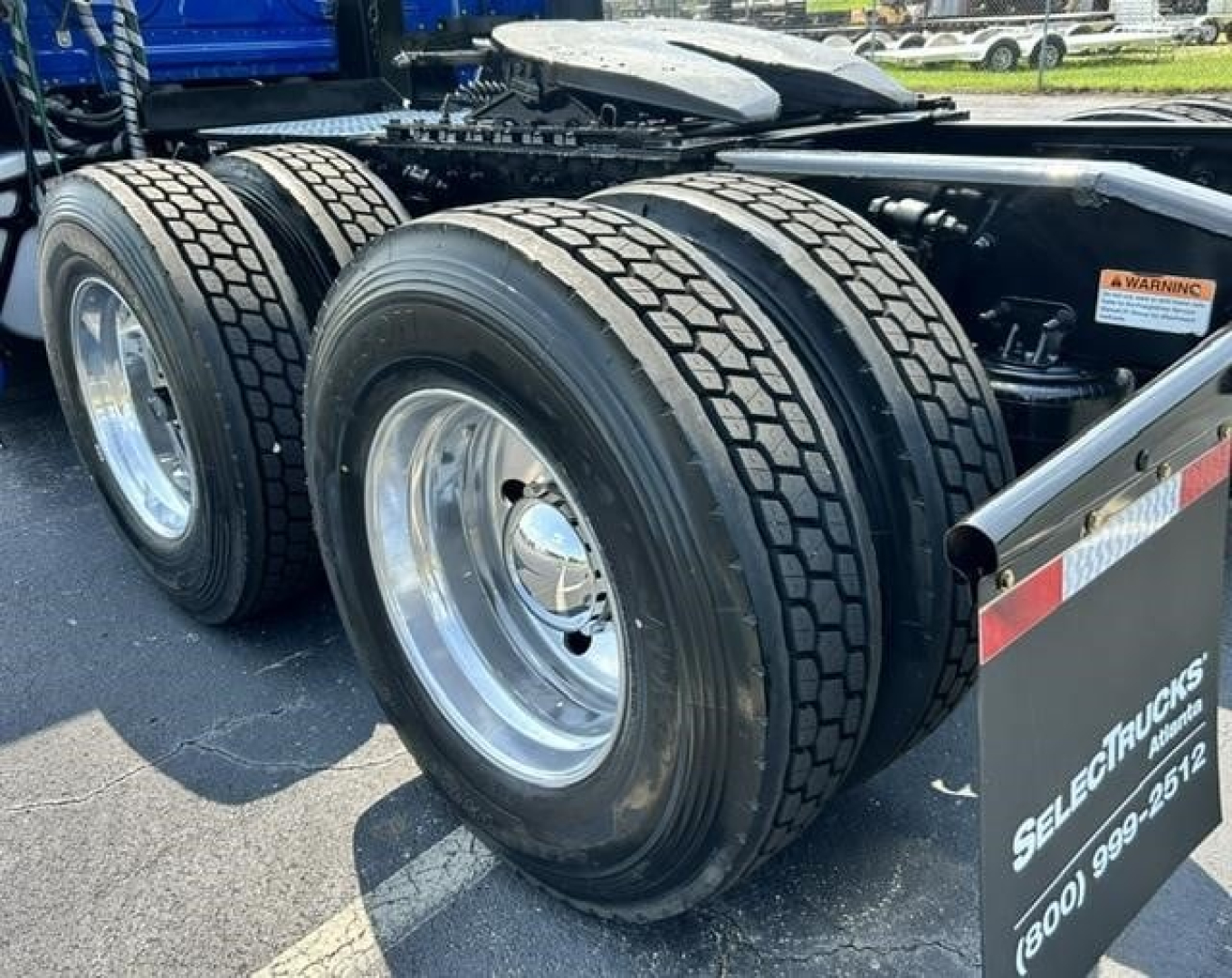 Freightliner Cascadia 126 tandem rear wheels and chassis showing dual rear axles and tire tread.