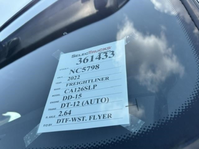 Sticker on windshield with vehicle details: STOCK 361433, VIN NC5798, YEAR 2022, MAKE FREIGHTLINER, MODEL CA126SLP, ENGINE DD-15, TRANSMISSION DT-12 (AUTO), R. AXLE 2.64, FWD DT-F WST FLYER.