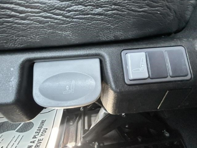 Freightliner Cascadia cab area showing hood release/dip switch and dashboard controls with a large square grey cap.
