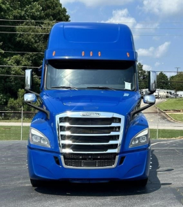 Blue Freightliner Cascadia 126 front view showing chrome grille, headlights, and large sleeper cab.