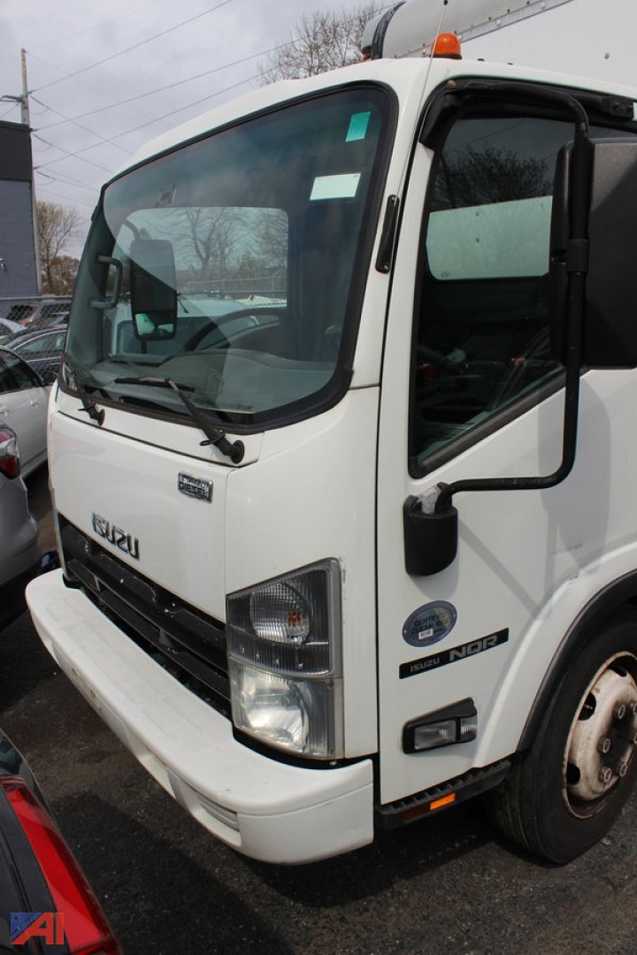 Isuzu NQR cab over engine box truck showing front cab and passenger side, lettering visible on grille and side badge