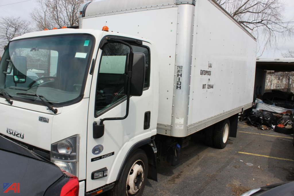 Isuzu box truck cab over engine with a white cargo box, side view, showing front cab and cargo area.