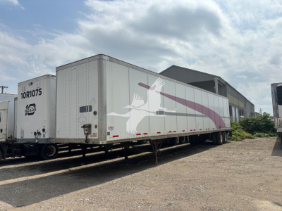 Trailer: 2015 Wabash DVCVHPC semi-trailer showing white body with purple graphic, two-tone wheels, parked on gravel with a building in background.