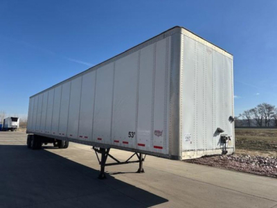 Trailer showing a side perspective of a 2014 Wabash van trailer with a raised front, silver exterior, and loading hitch; numeric markings near the bottom edge are visible.