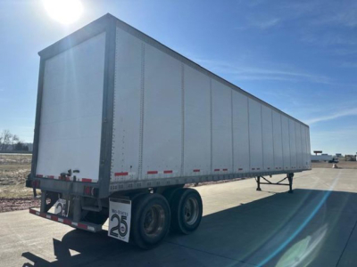 Trailer image showing a long white Wabash box trailer with tandem axles and rear bumper, stock number U90791.