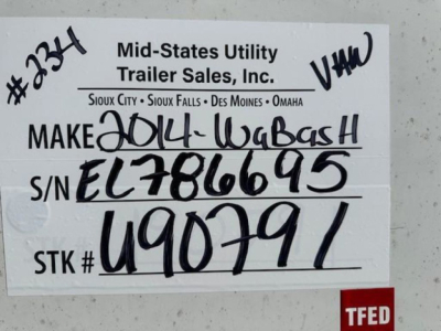 Trailer identification tag on a Wabash van showing stock number U90791 and S/N EL786695 with handwritten details.