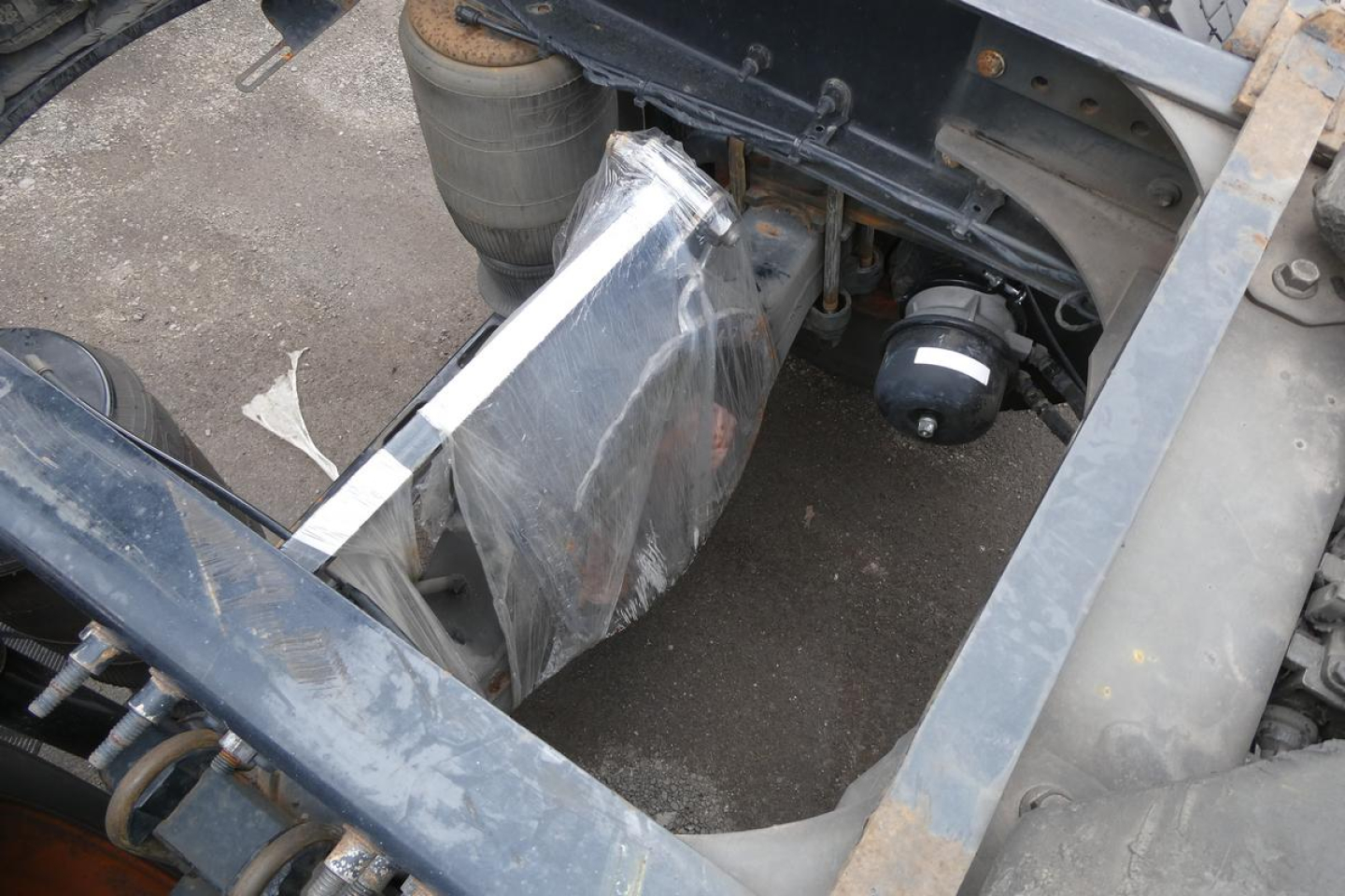 Truck bed area showing coolant reservoir and structural frame of Volvo VNM64T cab over or conventional daycab with exposed components