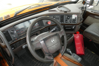 Volvo truck interior showing steering wheel, dashboard with gauges, and center console.