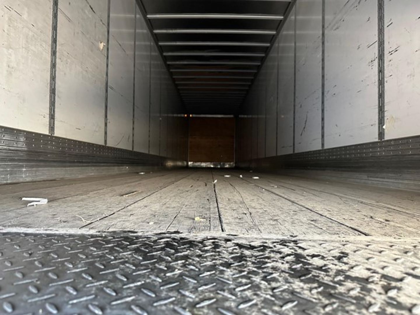 Trailer interior showing empty dry van cargo area with metal walls and floor