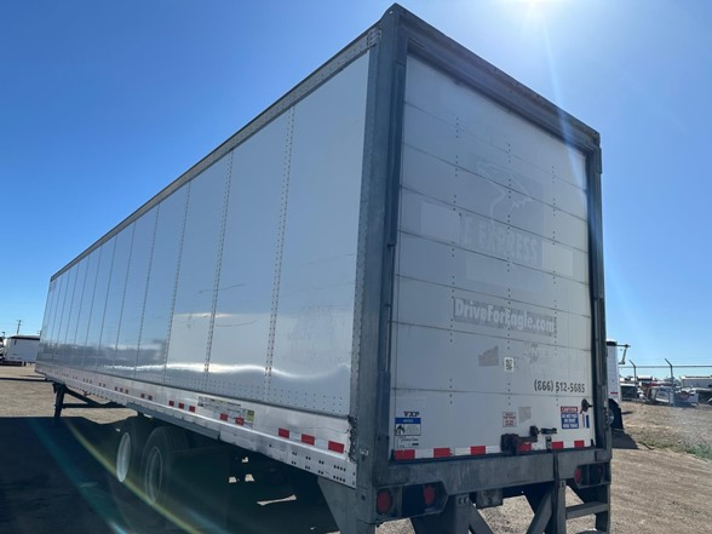 Vanguard air ride roll door dry van trailer in side/back view showing rear doors and reflective stripes.