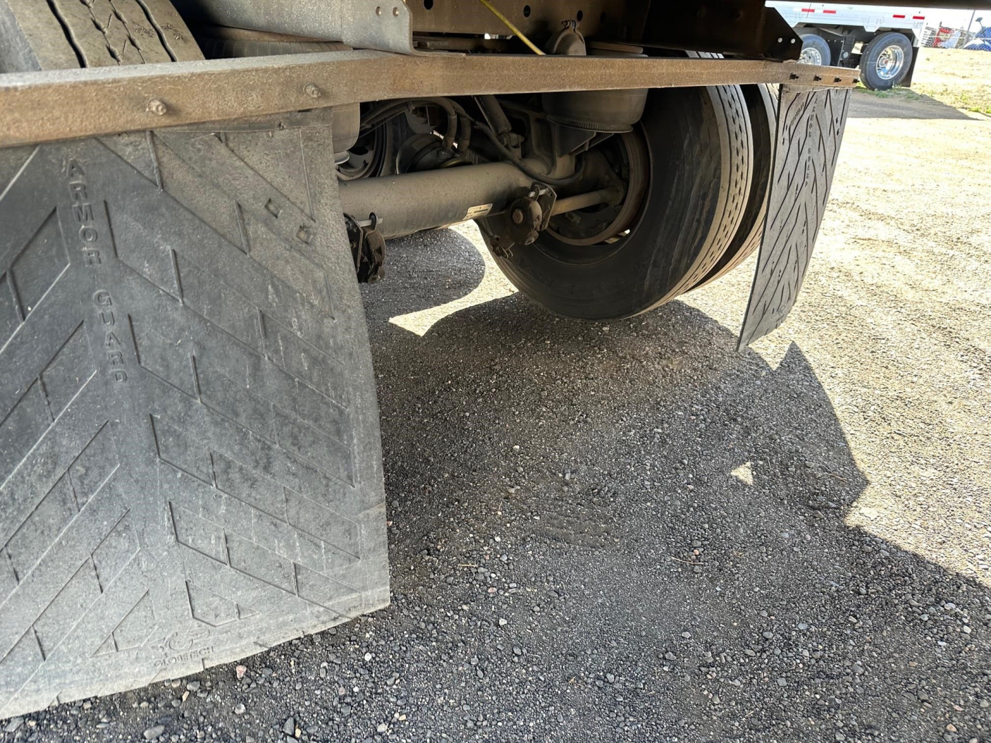 Trailer undercarriage showing rear wheel and mudflap of a Vanguard roll door dry van trailer.