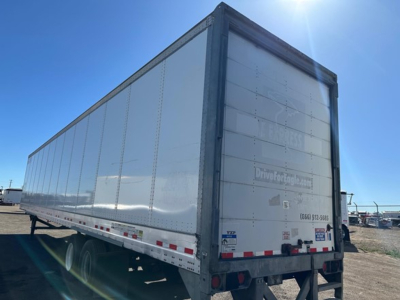 Vanguard air ride roll door dry van trailer in side/back view showing rear doors and reflective stripes.