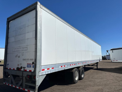 2017 Vanguard air-ride roll-door dry van trailer side view showing dual rear axles and reflective tape along the lower side; VIN and stock number not visible