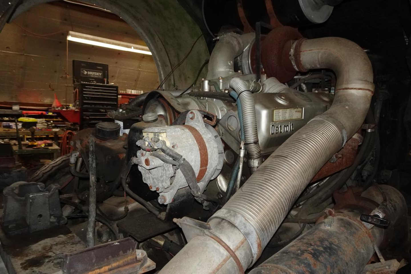 Engine bay of a 1991 KME fire truck showing large turbo piping, hoses, and components with labels partially visible.