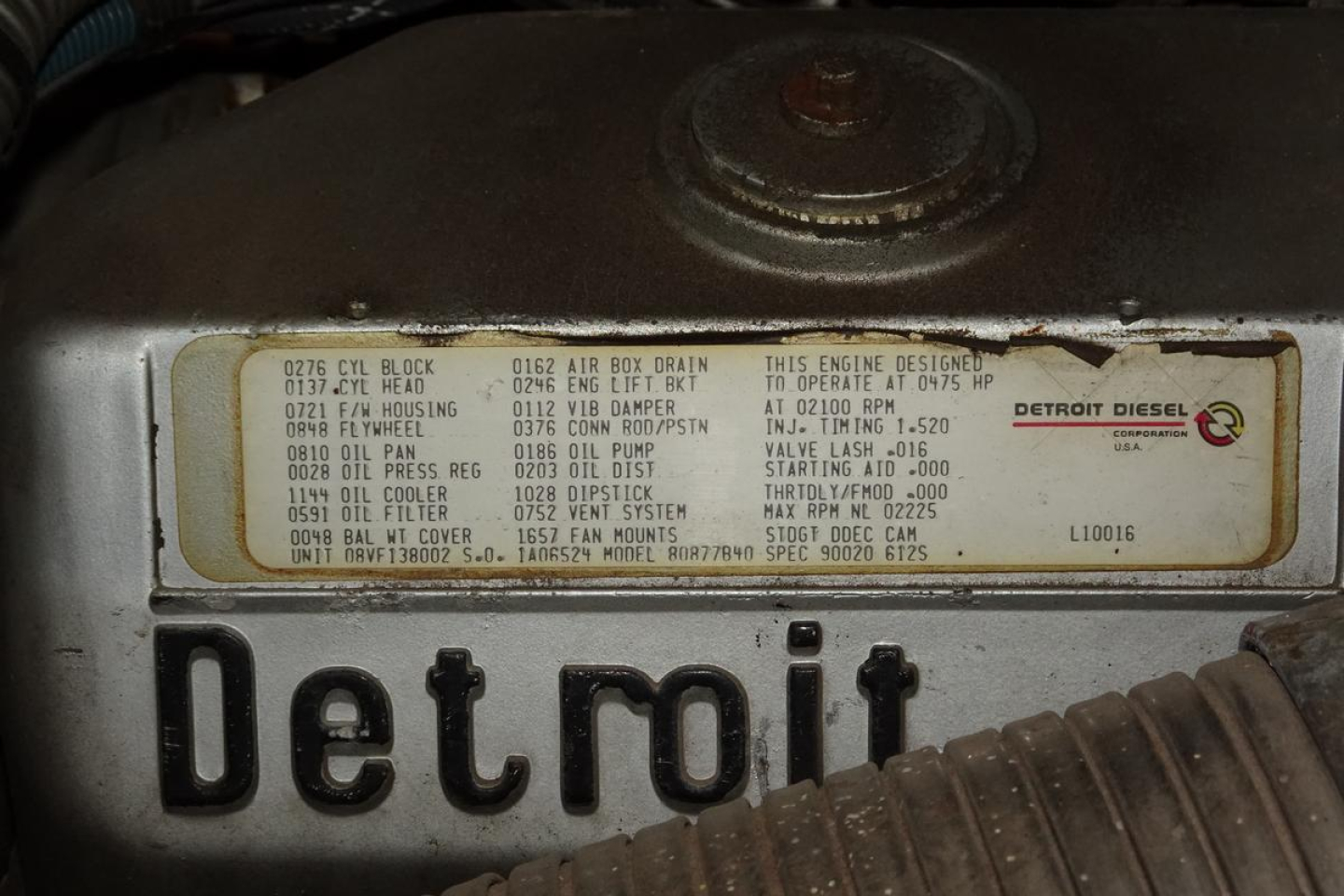 Detroit Diesel engine bay showing engine label with part numbers and specs on a metal plate attached to the engine block.