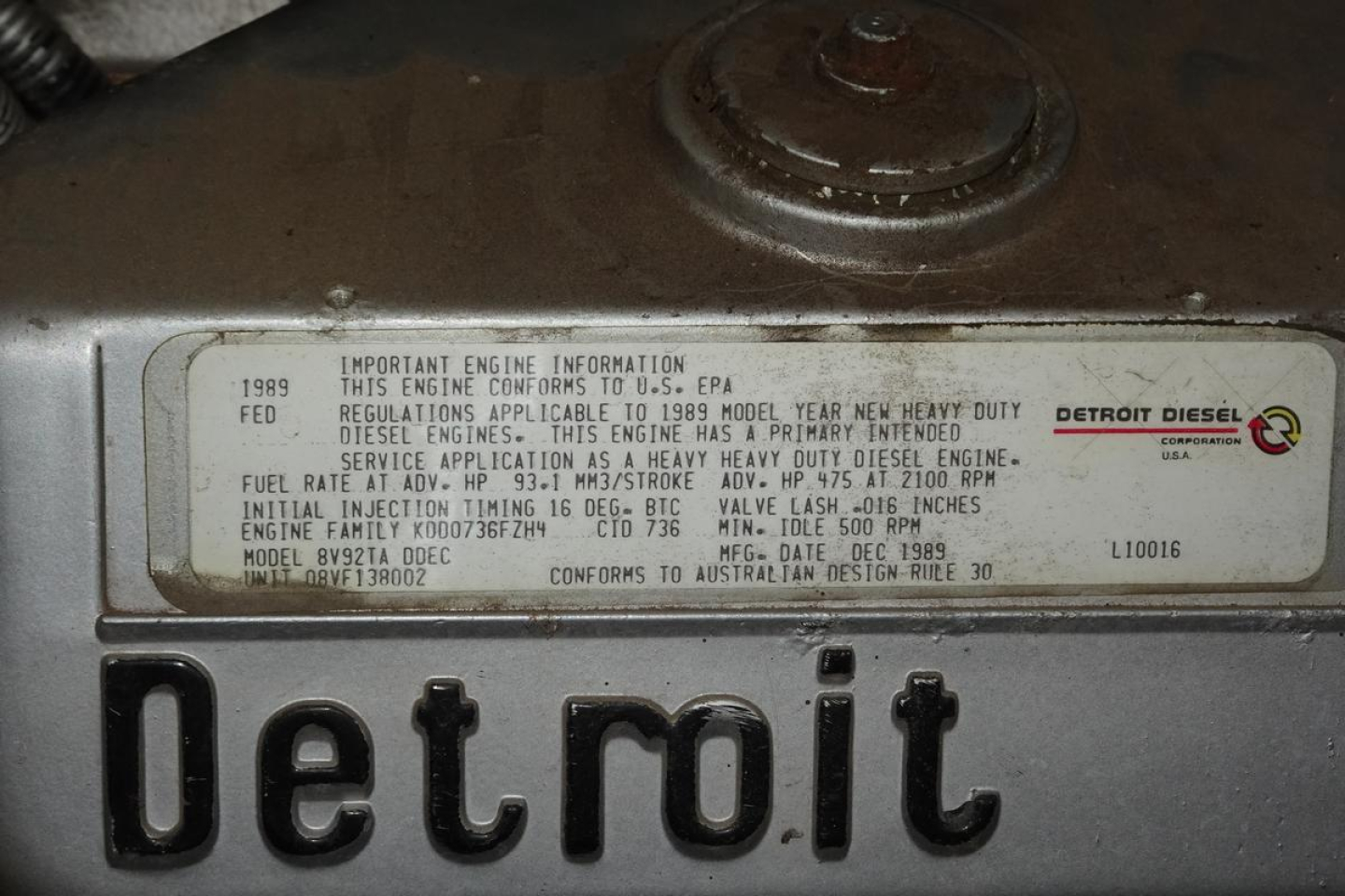 Detroit diesel engine data plate on a 1991 KME fire truck showing model and specifications. The label includes 'Detroit Diesel', 'IMPORTANT ENGINE INFORMATION', '1998 FED REGULATIONS APPLICABLE TO 1989 MODEL YEAR HEAVY DUTY DIESEL ENGINES',