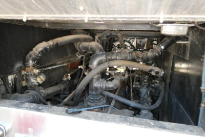 Fire truck engine bay showing multiple hoses and components