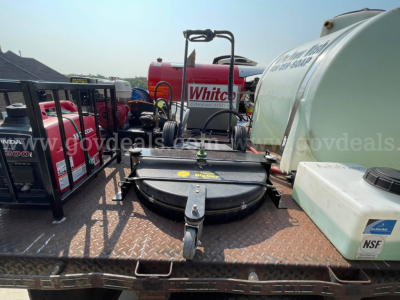 Ford F-350 service/utility truck setup showing various equipment including a front-mounted mower/rotary unit and storage tanks.