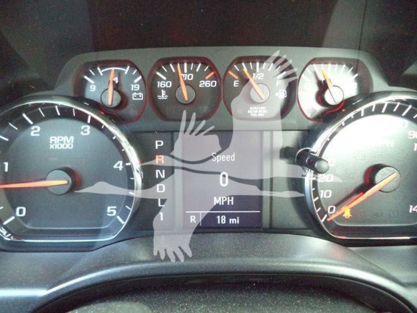 Dashboard view of a 2023 Chevrolet Silverado 6500HD showing multiple gauges and a digital display with gears P R N D L, speed 0 MPH, 18 mi, and a watermark overlay.