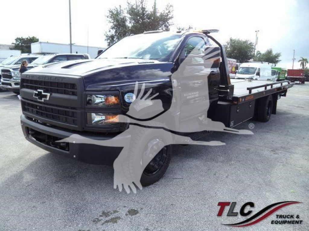 Chevrolet Silverado 6500HD rollback tow truck in black with flatbed, front grille emblem visible, stock number printed.