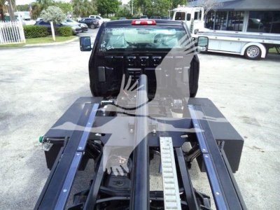  Silverado 6500HD rollback truck chassis with heavy-duty frame and wheel-lift bed seen from rear cab area, black components and toolbox shelves.