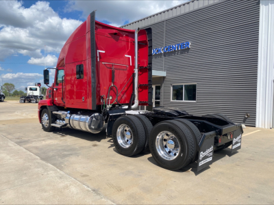Mack AN64T70 conventional sleeper truck in red, side view showing cab and chassis with dual rear axles and chrome fuel tanks.