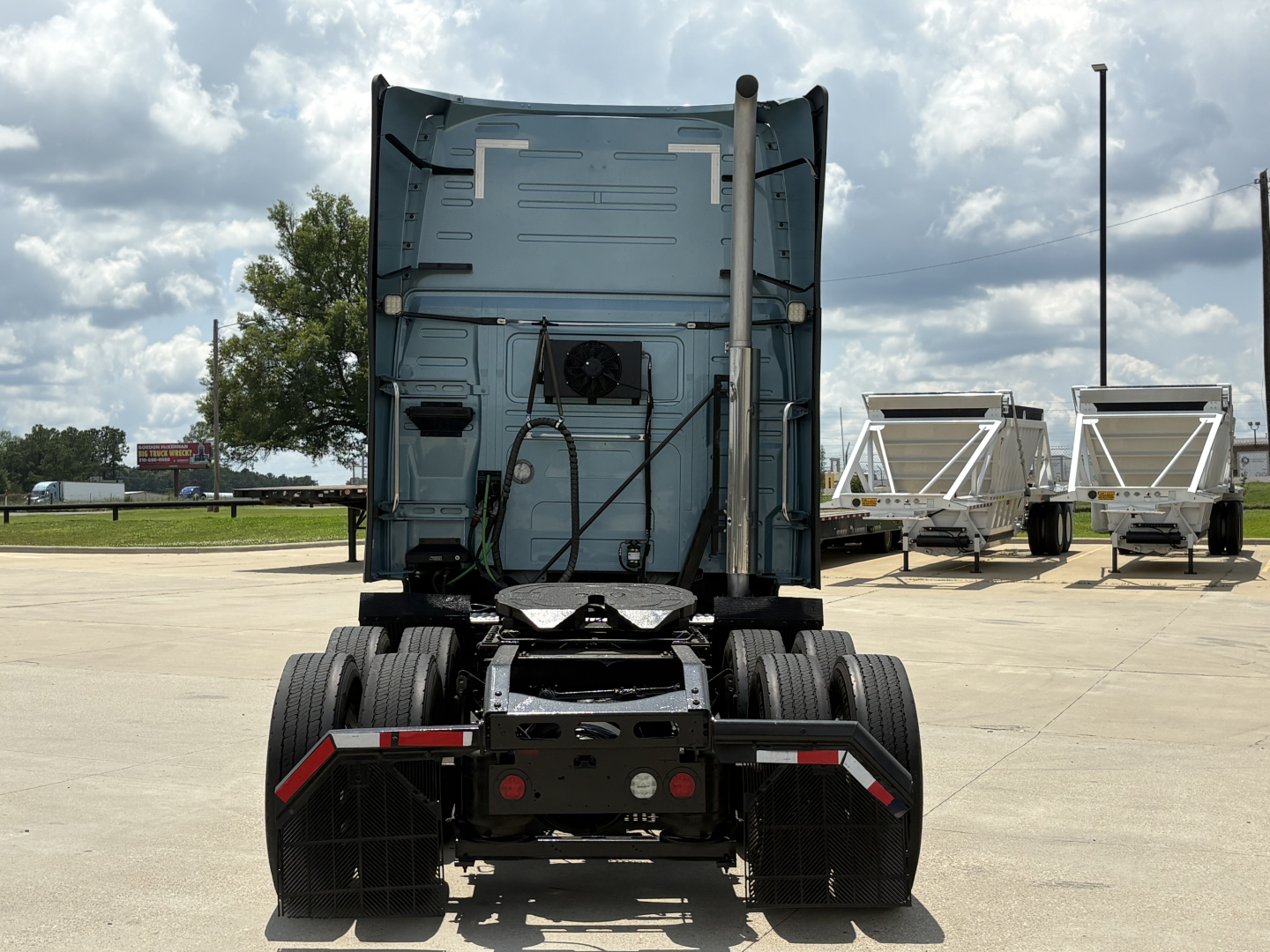 Back view of a Volvo VNL64T760 truck tractor showing rear chassis and fifth wheel with dual rear axles.