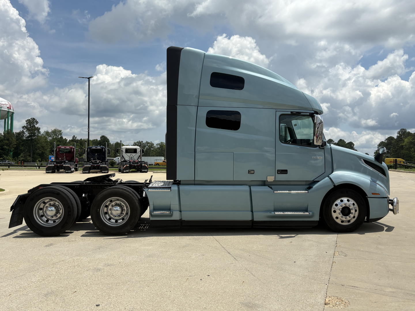 2022 Volvo VNL64T760 tractor side profile showing sleeper cab and dual rear axles.