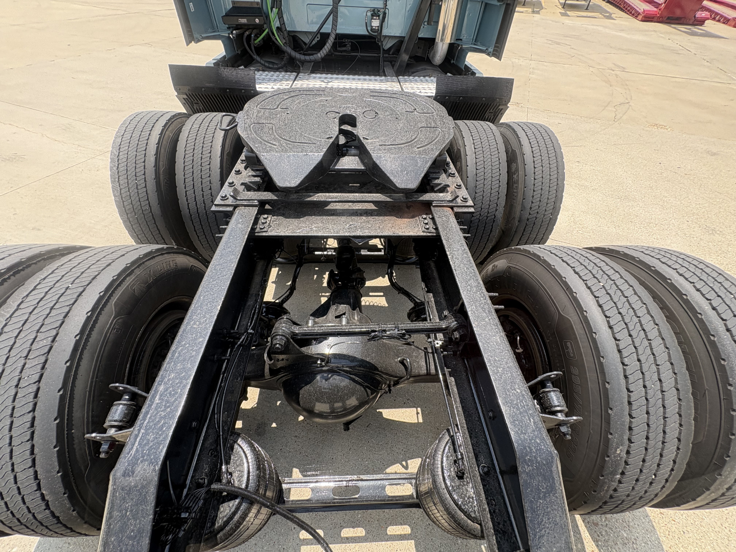 Volvo VNL64T760 tractor cab view showing rear axle and fifth wheel mounting plate with dual rear dual tires.